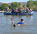 A group of people in a raft floating down the river.